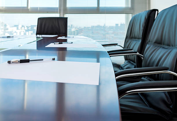 ready for a meeting Corporate boardroom with blank paper set for the meeting. shareholders meeting stock pictures, royalty-free photos & images