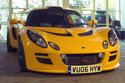 London, England - March 18th 2015. A Lotus Elise sports car sits outside a cafe in London at night.