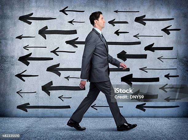 Businessman Walking In Wrong Direction Stock Photo - Download Image Now - Walking, Businessman, Profile View