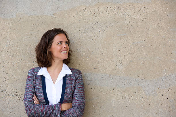 istock Smiling business woman standing with arms folded 482336736