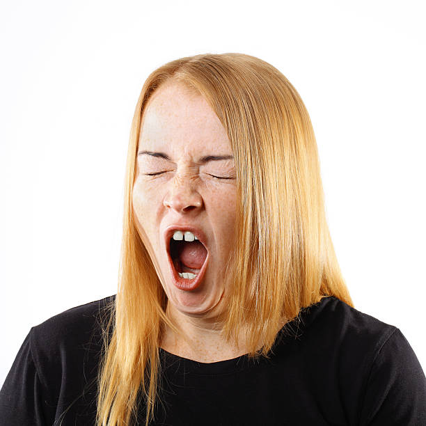 istock Young Woman Yawning Portrait. 482337409