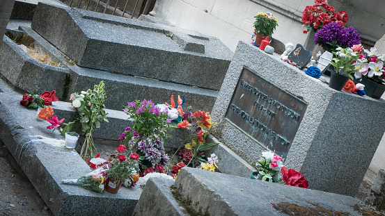 Paris, France - July 15, 2015: Jim Morrison's, the American legendary rock star's grave where the occasional tourist leaves a tribute, a flower or a note.