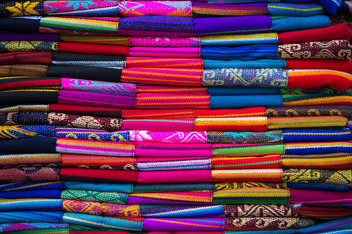 Laotian woman selling handmade textiles on a morning market in Luang Prabang, Laos