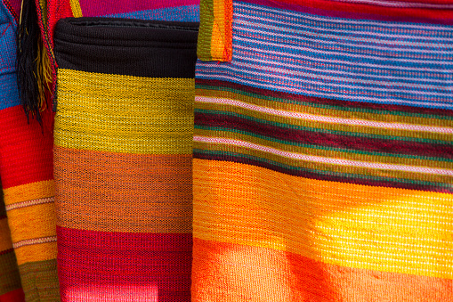 Background of colored Ecuadorian textile at the market of Otavalo in Ecuador, 2015.