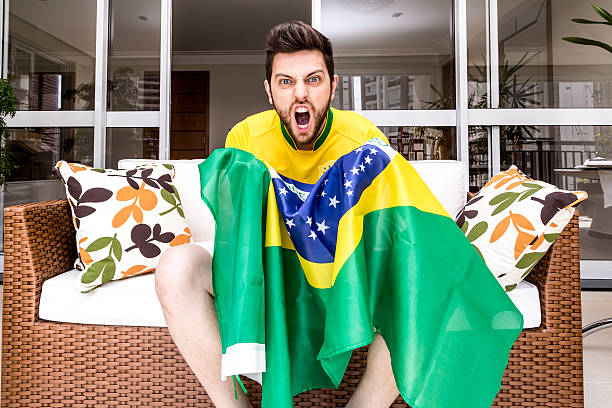 istock Brazilian fan celebrates at home 482339071
