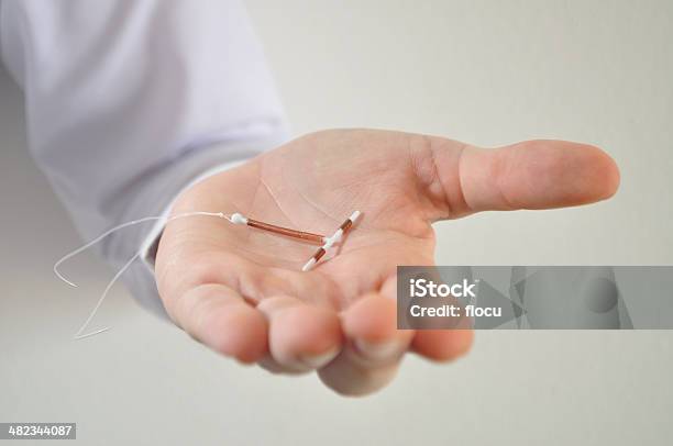 Holding An Iud Birth Control Device In Hand Stock Photo - Download Image Now - IUD, Contraceptive, Spiral