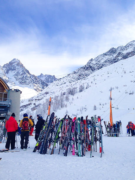 Winter landscape.  Women snow skiers skiing, enjoying on sunny ski resorts. Perfectly prepared ski slopes.  At the top of the  high snowy mountain.  Dolomites Mountain range in Italy.  