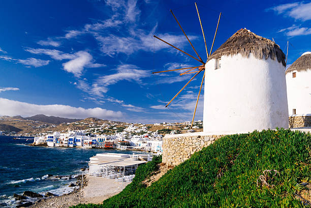 White famous windmills overlooking Little Venice and Mykonos old town, Mykonos, Cyclades, Greece