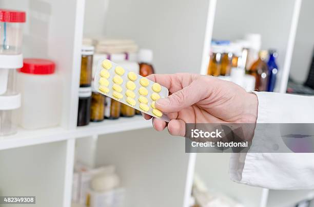 Hand Holding A Blister Of Pills Stock Photo - Download Image Now - 2015, Blister, Capsule - Medicine