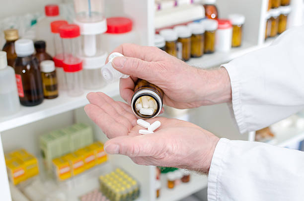 istock Doctor pouring medicine pills in hand 482349322