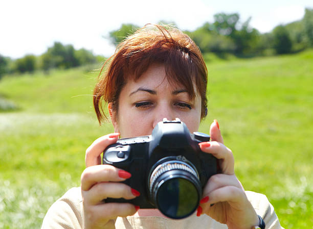 istock Woman photographer with camera 482350228