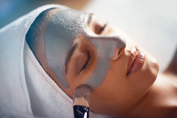 On her way to gorgeous skin Shot of a young woman enjoying a facial treatment at a spahttp://195.154.178.81/DATA/i_collage/pi/shoots/783696.jpg facial mask beauty product stock pictures, royalty-free photos & images