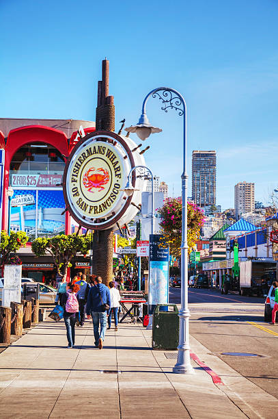 Famous Fisherman's Wharf of San Francisco San Francisco, USA - April 24, 2014: Famous Fisherman's Wharf sign with tourists in San Francisco, California. It's one of the busiest and well known tourist attractions in the western United States. fishermans wharf san francisco photos stock pictures, royalty-free photos & images