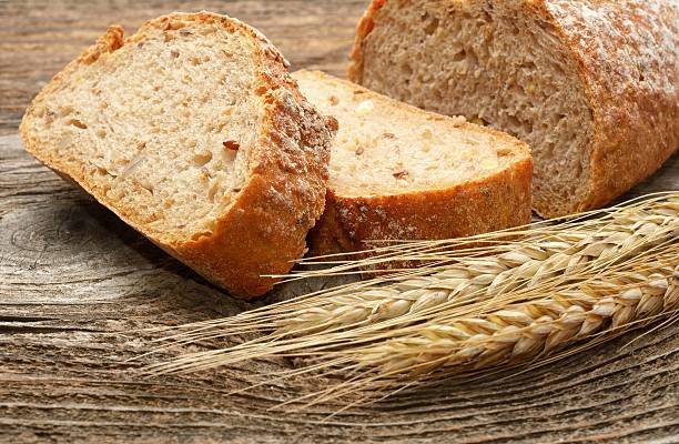istock fresh bread and wheat on wooden background 482352784