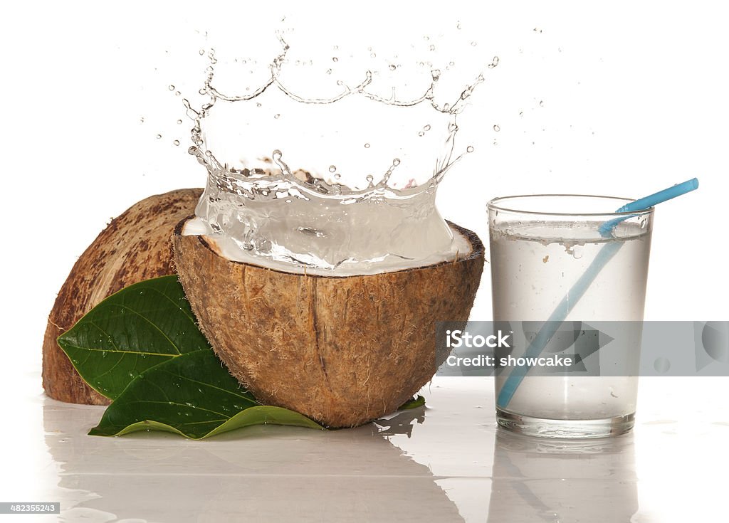 Coconut with water splash over white Alcohol - Drink Stock Photo