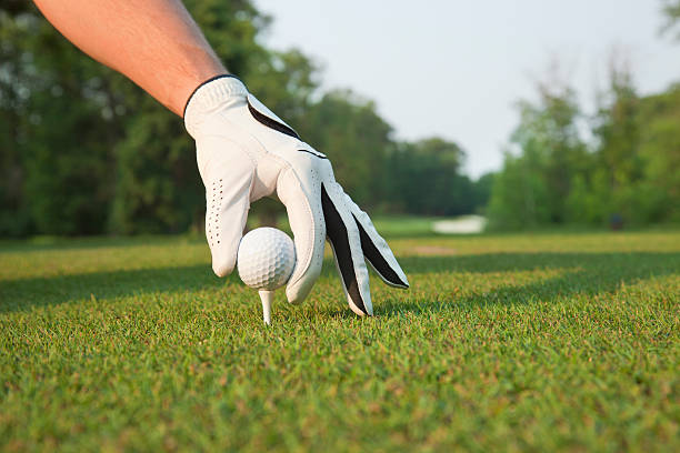 istock Selective foccus of golfer's hand placing ball on tee 482355940