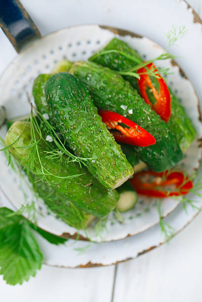 istock freshly-salted cucumbers on vintage enamel sieve 482358900