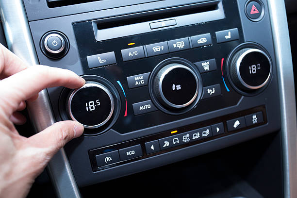 istock Man's hand tuning radio in the car 482359818