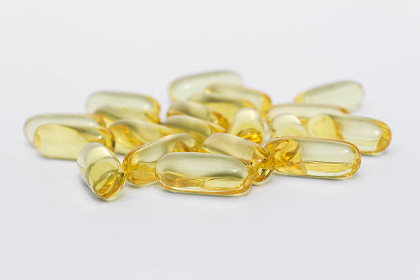 istock orange capsules, vitamin pills isolated on white background 482360054