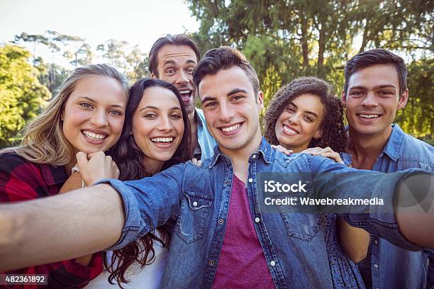 Happy Friends Taking A Selfie Stock Photo - Download Image Now - Friendship, Social Gathering, Green Color