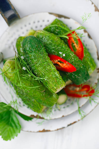istock freshly-salted cucumbers on vintage enamel sieve 482365070
