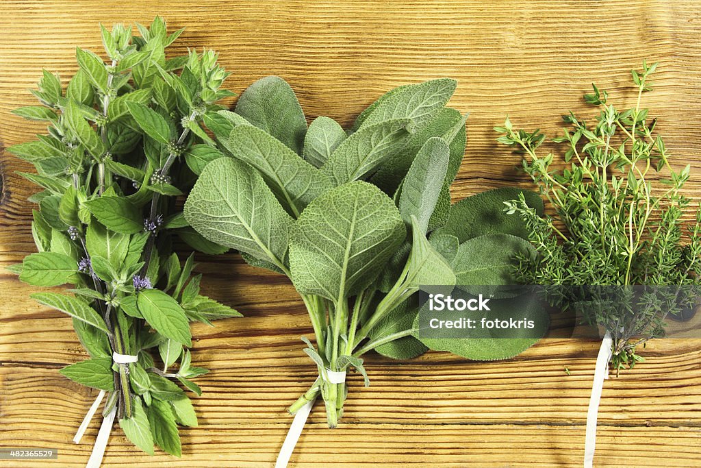 Fresh herbs Bunch of fresh herbs on wooden background Alternative Medicine Stock Photo