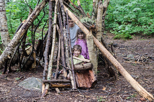 Three kids in the wooden shelter