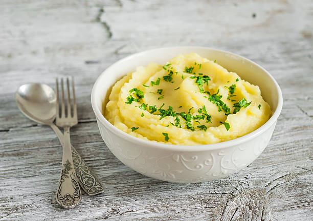 istock mashed potatoes in a white bowl on a light wooden background 482368802