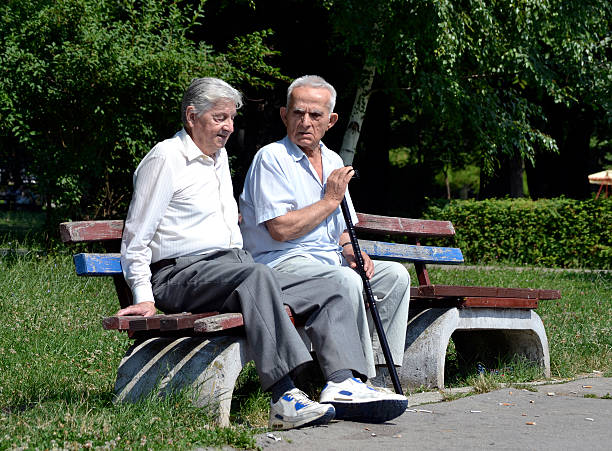 istock Two old gentleman talking in the park 482370414