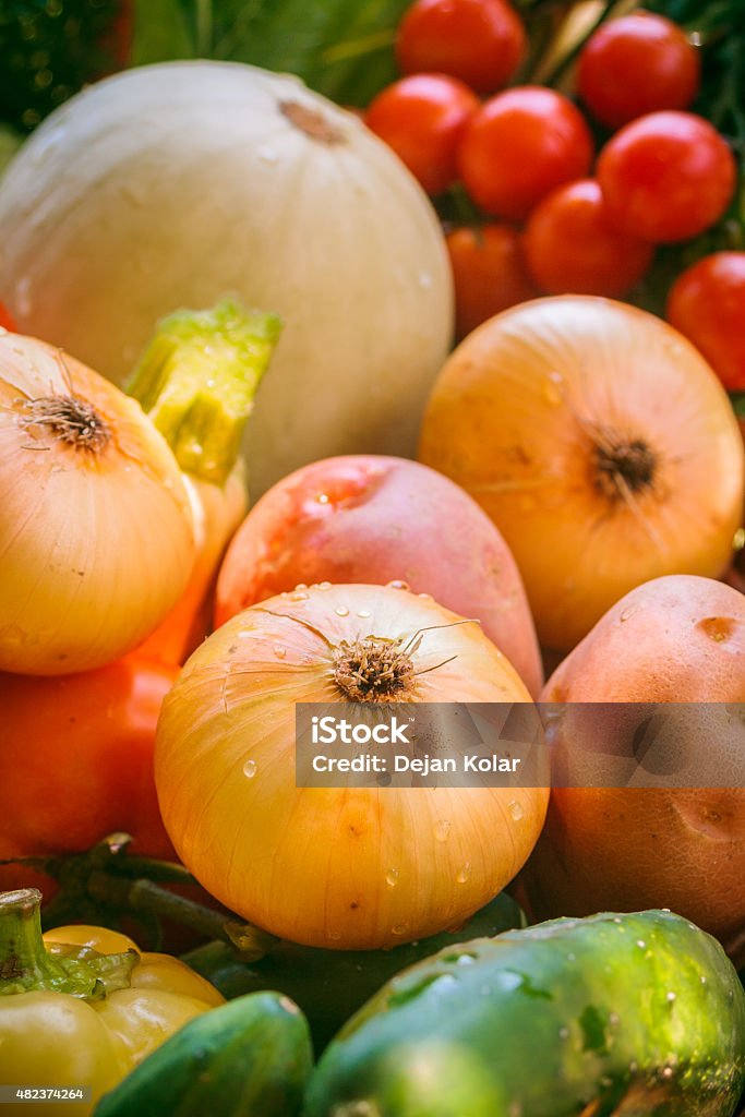 Wicker basket with fresh vegetables Wicker basket full of fresh healthy imperfect organic homegrown vegetables. Carrots,tomatoes, cherry tomatoes, peppers, paprika, potatoes, onions, zucchini, beetroot and Chard. 2015 Stock Photo