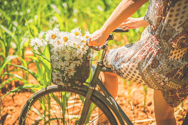 istock Women bicycle and flowers 482374642