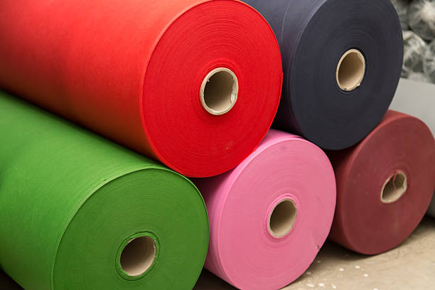 istock Colorful material fabric rolls in warehouse 482375188