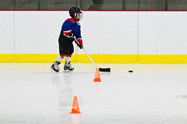 istock Child practices stickhandling at ice hockey practice 482375857