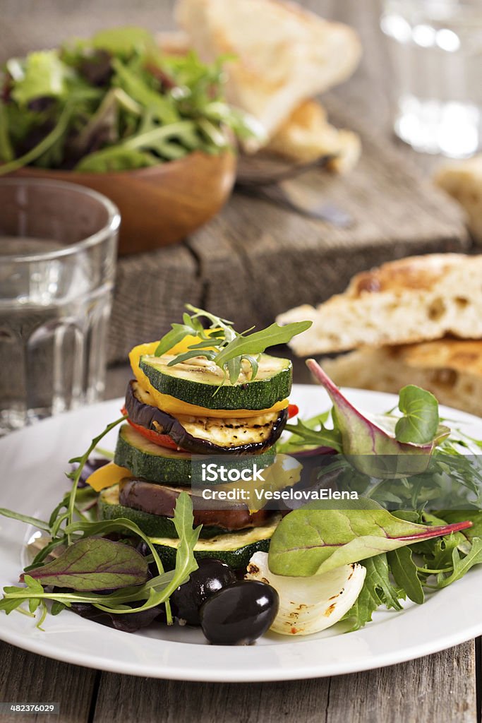 Grilled vegetables stacked on plate Grilled vegetables stacked on plate with salad leaves Appetizer Stock Photo