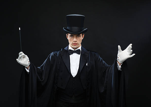 istock magician in top hat with magic wand showing trick 482376389