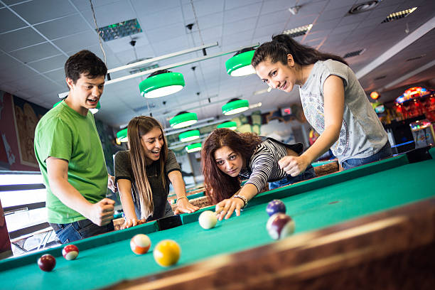 istock Group of friends playing pool 482376670