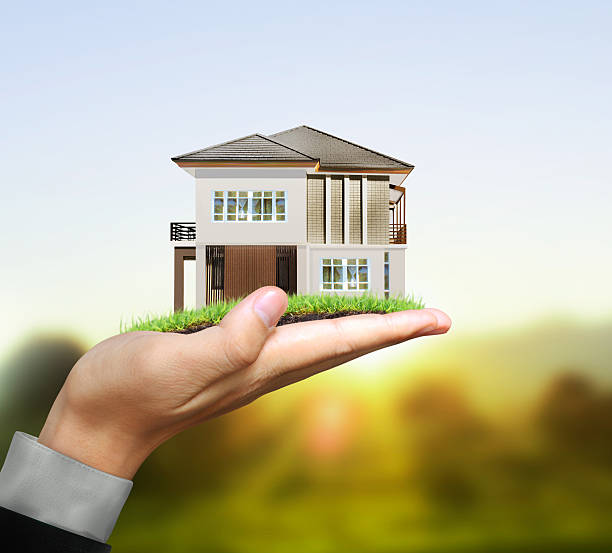 istock Businessman holding house model 482377410