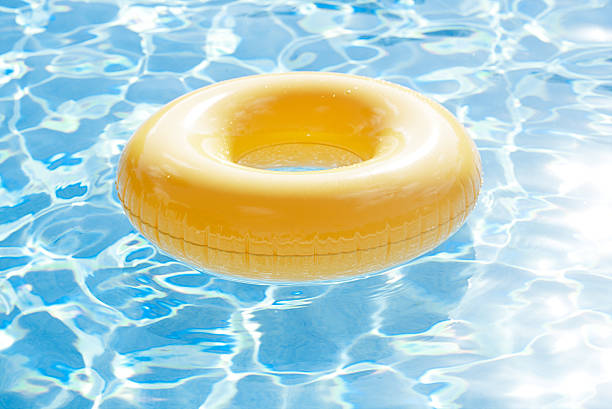 istock floating ring on blue water swimpool with waves reflecting 482377632