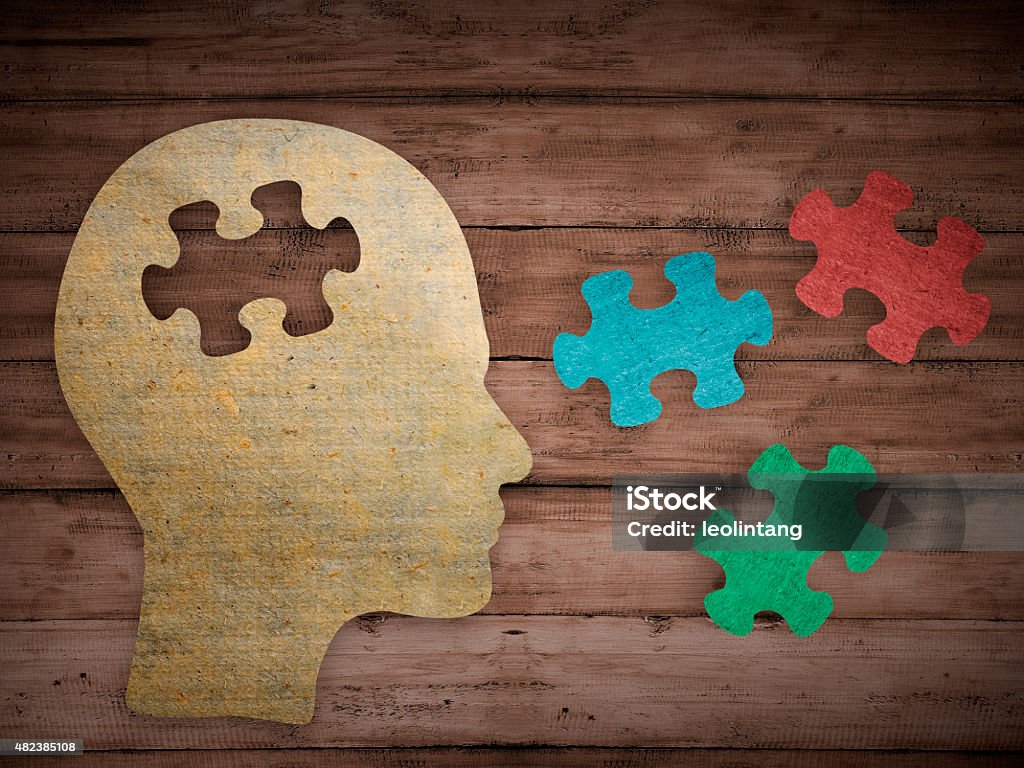 Choose your personality that matching you Puzzle head brain concept. Human head profile made from brown paper with a jigsaw piece cut out. Choose your personality that suit you Mental Health Stock Photo