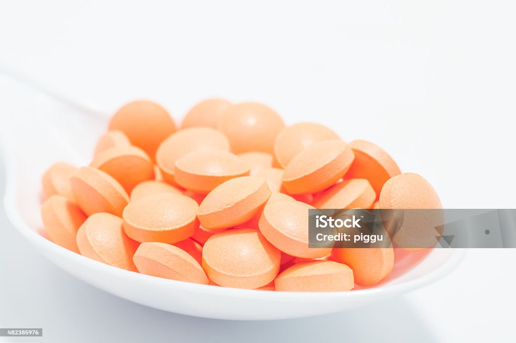 pills orange pills on the white spoon 2015 Stock Photo