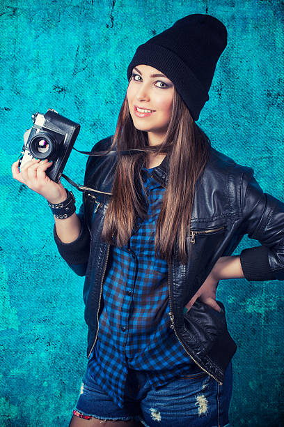 istock beautiful young woman holding camera 482390029