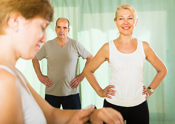 istock Mature couple with trainer at gym 482391590