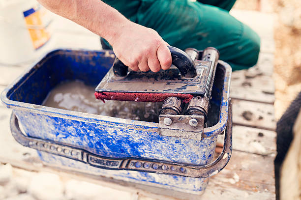 istock Man putting natural stones on a wall 482392410