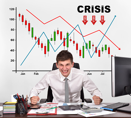 angry businessman and drawing crisis chart on wall