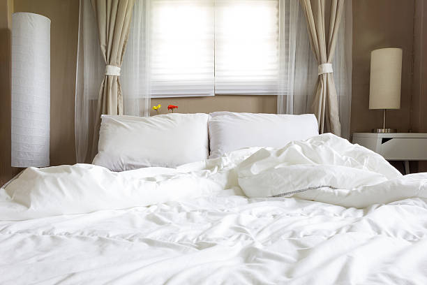 istock white bed in small brown bedroom for interior 482392560