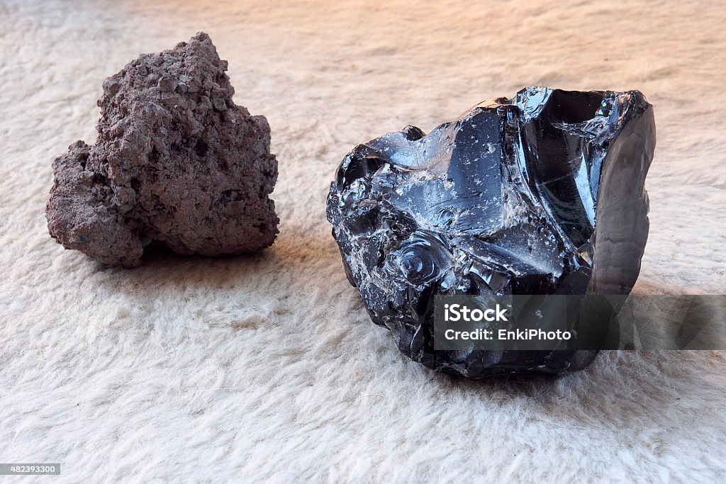 Lava stone and black obsidian stone. Lava stone and obsidian stone from a free beach of the Lipari island , one of the Aeolian Islands in Sicily, Italy.   Obsidian Stock Photo