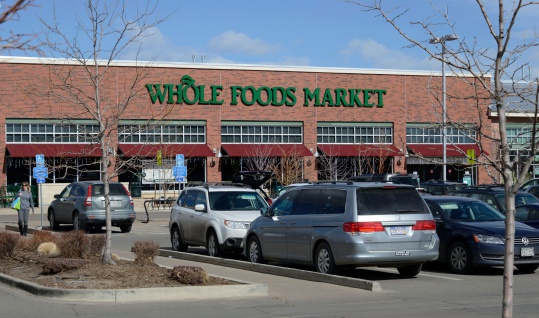Boulder, Colorado, USA - February 19, 2014: A person near the Whole Foods Market in Boulder. Whole Foods is a chain of grocery stores specializing in organic foods among other things, with locations throughout the country.
