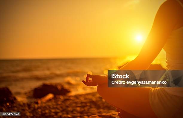 Hand Of Woman Meditating In A Yoga Pose At Sunset Stock Photo - Download Image Now - Activity, Adult, Adults Only