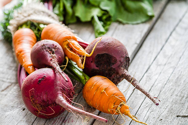 Carrot and beet on rustic background Carrot and beet on rustic background root vegetable stock pictures, royalty-free photos & images