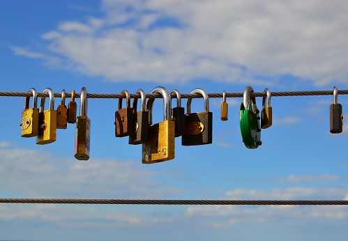 Rewal, Poland - August 26, 2012: padlocks on the railing of a bridge as a promise of eternal love
